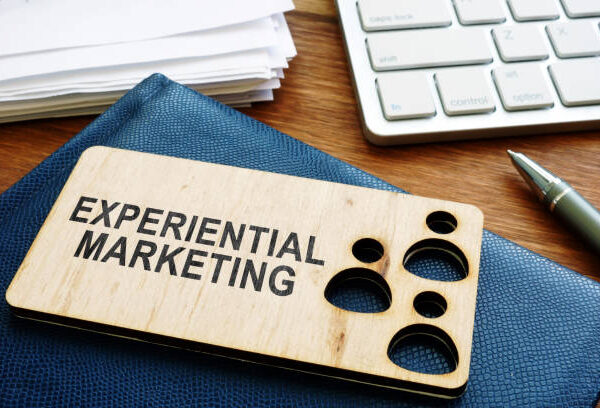 Experiential marketing concept. Stack of plans and keyboard.